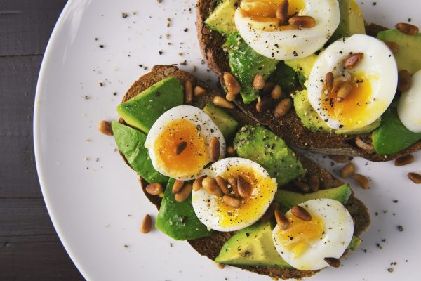 Healthy food snack of eggs and avocado on toasted bread
