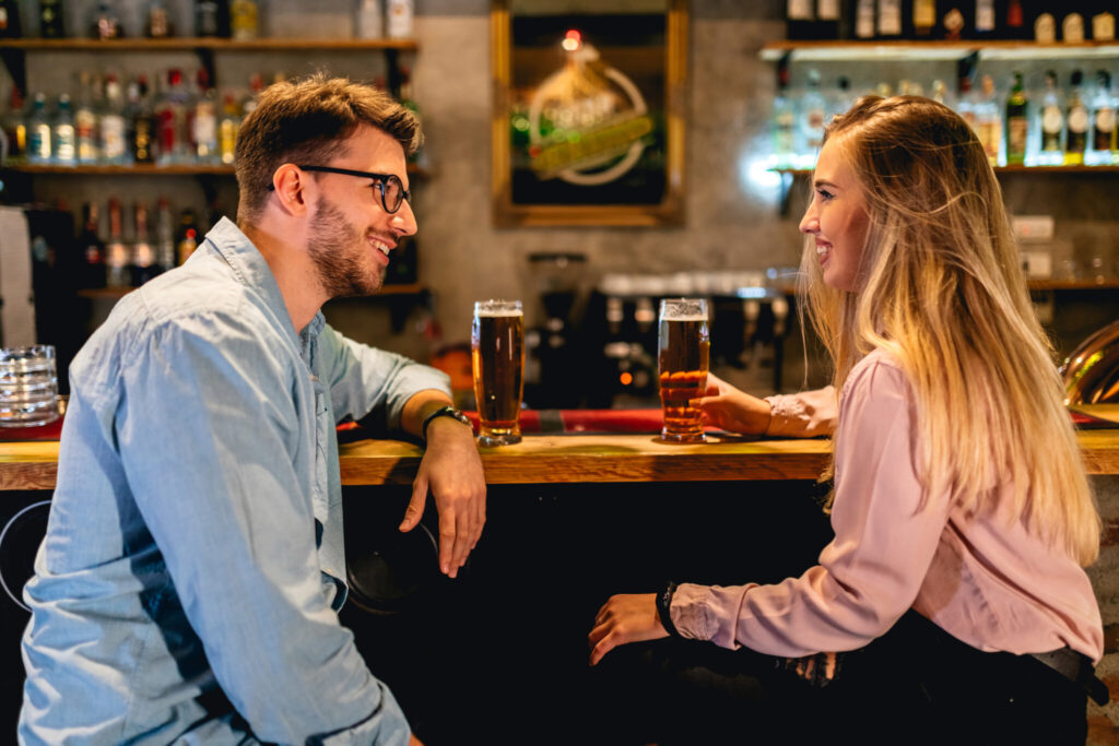 Young man and woman on first date in pub