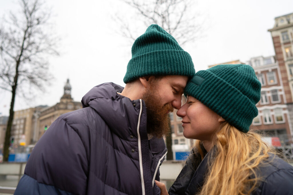 A loving couple man and woman in winter warm clothes embracing