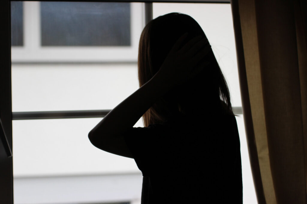 Side View Of Silhouette Woman Standing By Window