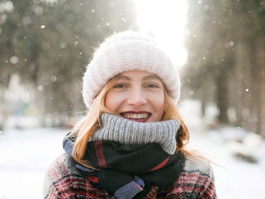 Caucasian woman smiling in snow