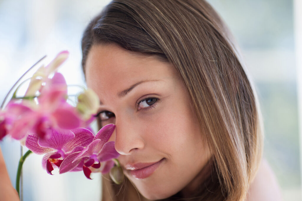 Serene woman looking at orchid
