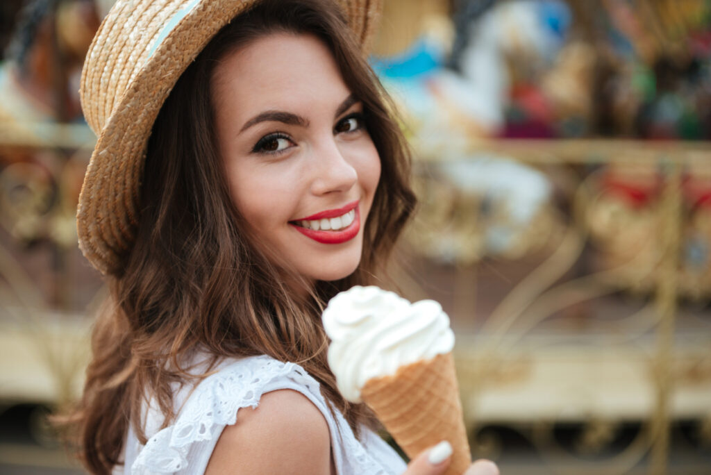 Close up portrait of a smiling girl with ice cream