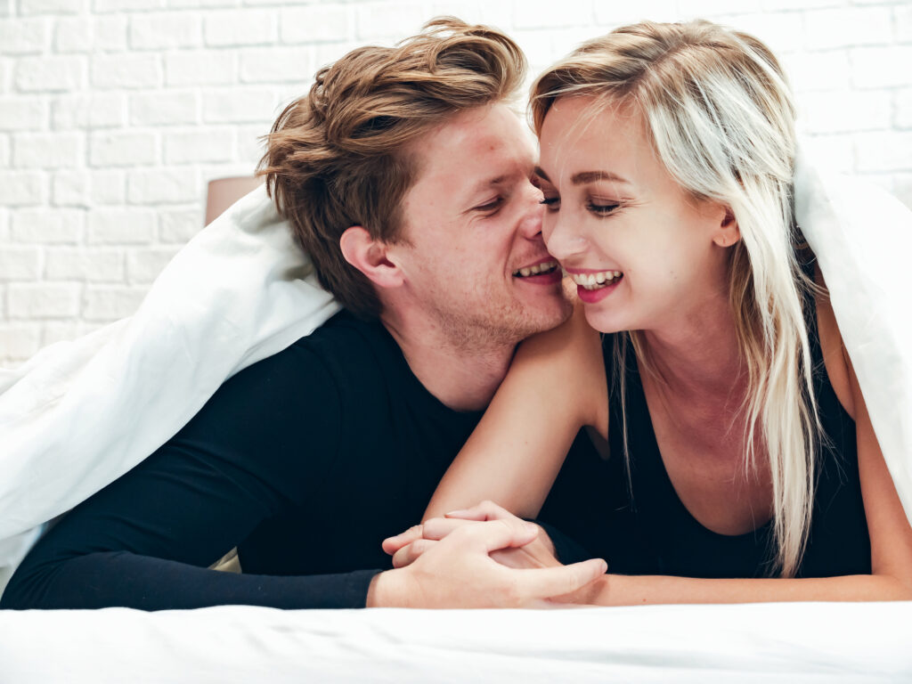 romantic couple feeling loving on bed in bedroom ,attractive girlfriend and boyfriend relax in the holiday , People lifestyles concept.