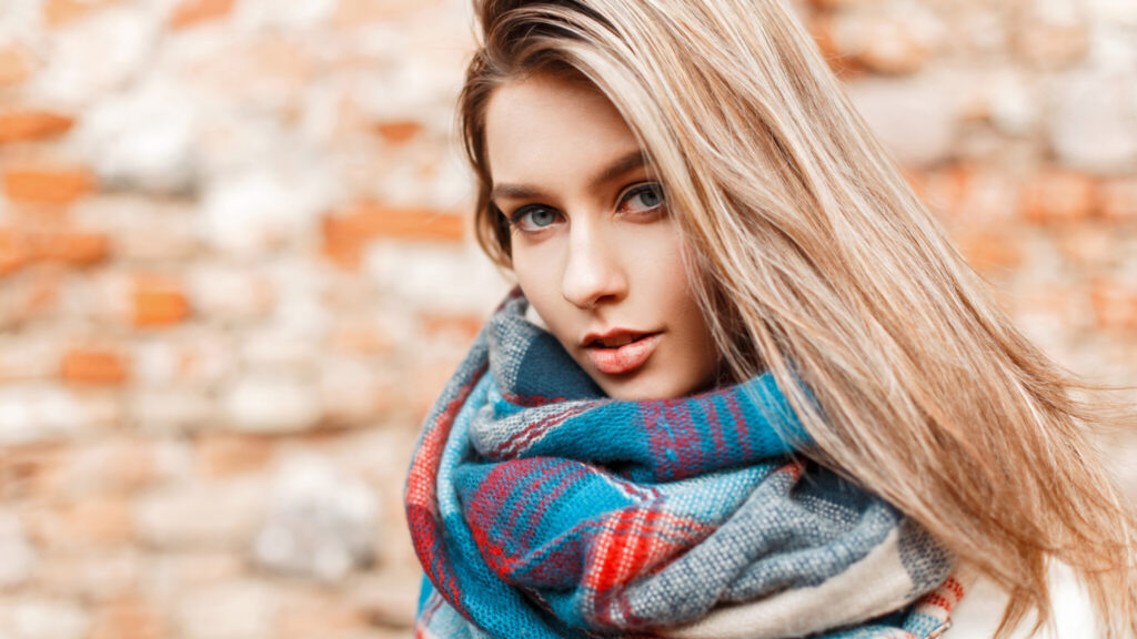 Portrait of a beautiful young woman with blue eyes on the street