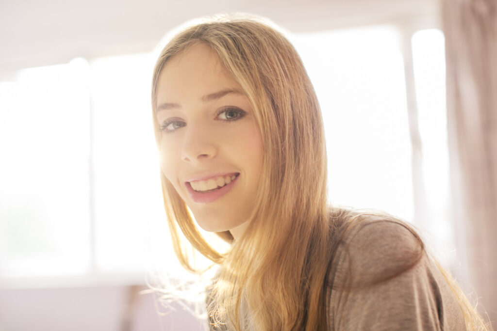 Portrait smiling blonde teenage girl