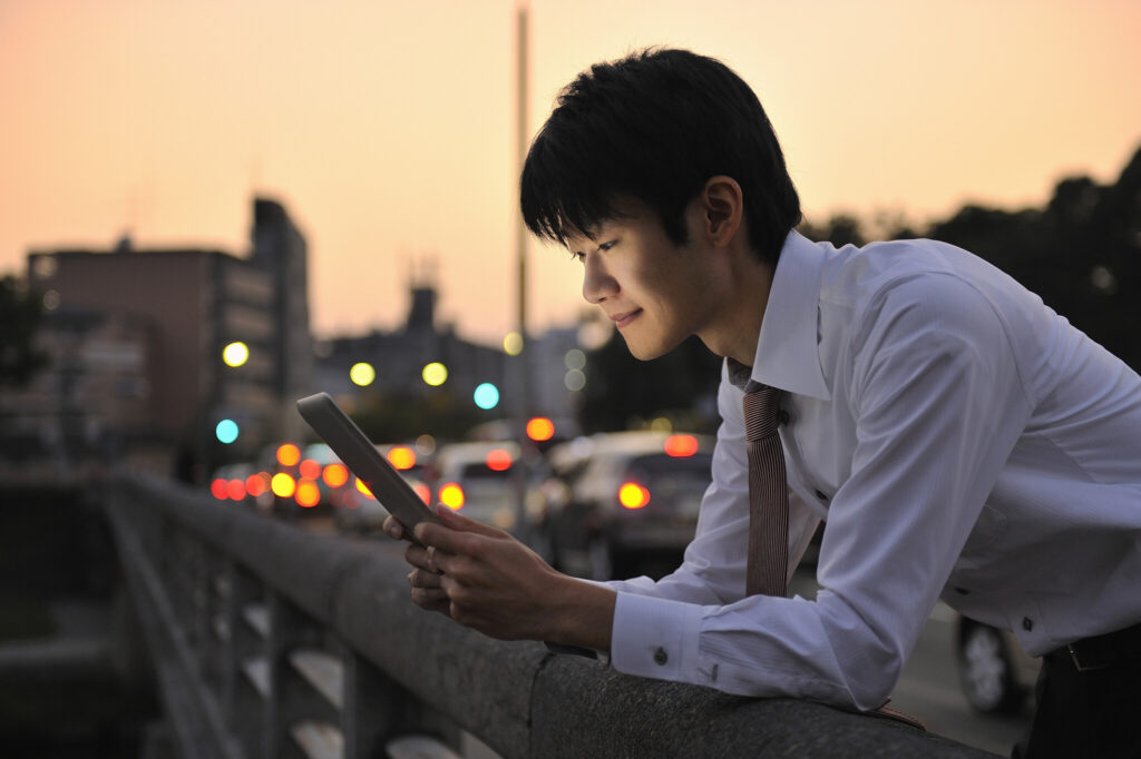 Businessman using digital tablet in city