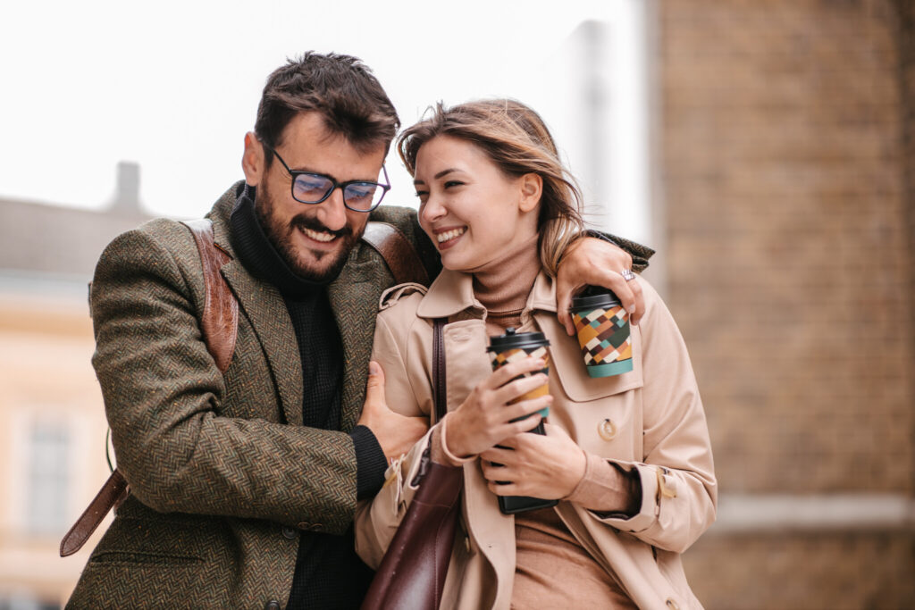 Couple hugging and drinking coffee
