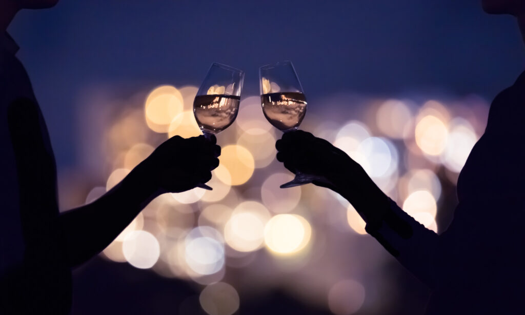 Couple enjoying a glass of wine in the city at night