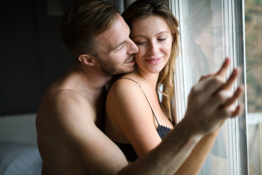 Attractive couple sharing intimate moments in bedroom