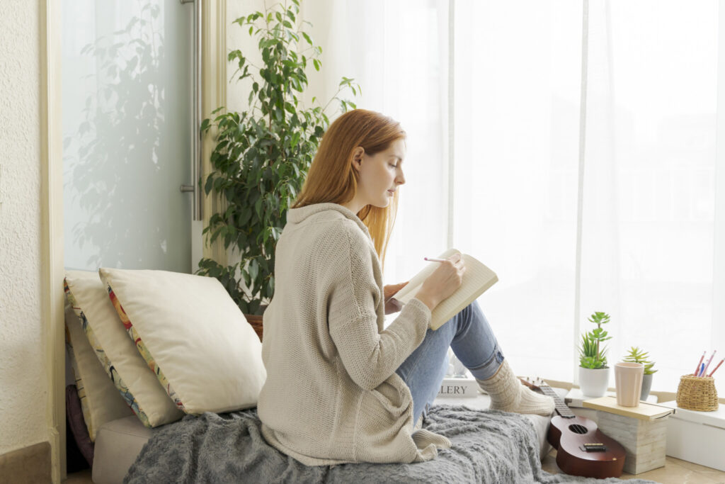 Young woman taking notes at home