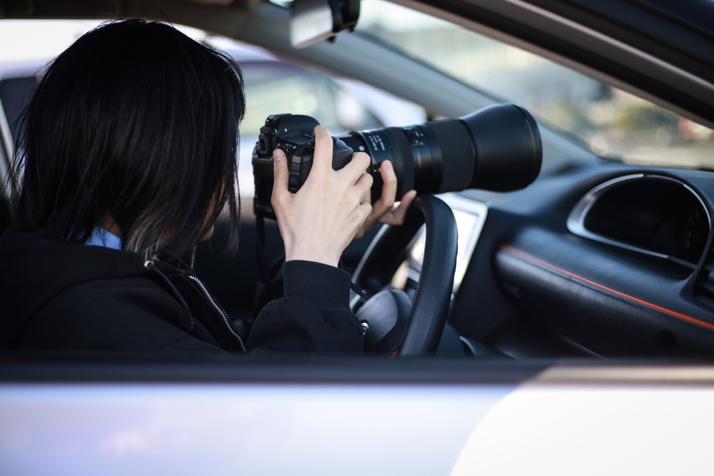 Woman,Taking,Pictures,From,Inside,The,Car
