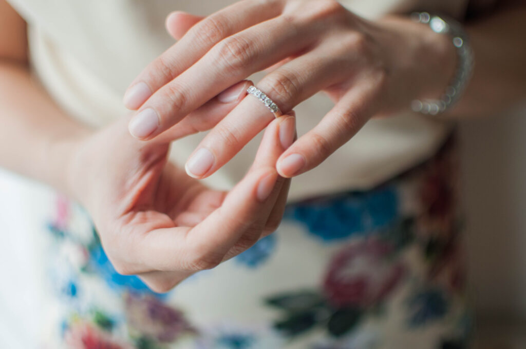 A young woman is wearing her wedding ring