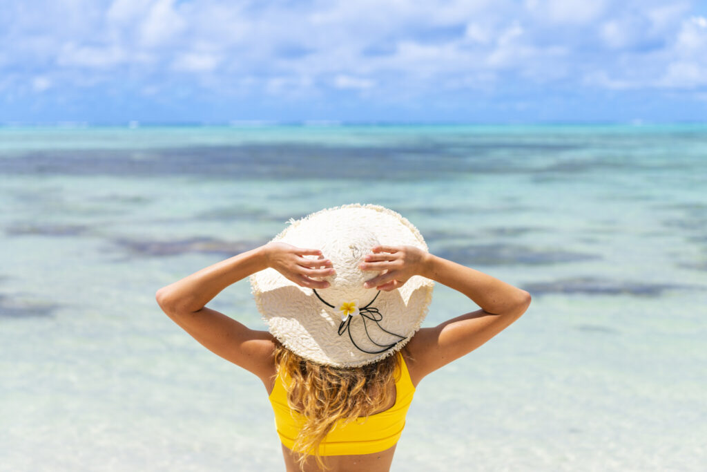 Rear view of woman relaxing on tropical beach