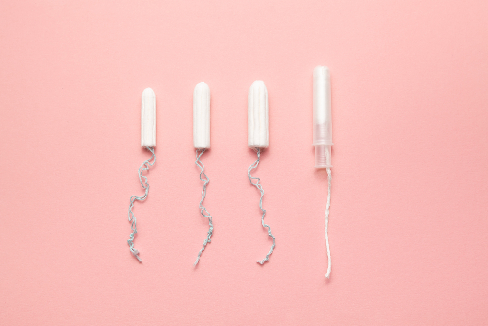 Unpacked,Different,Sizes,And,Types,Tampons,On,A,Soft,Pink